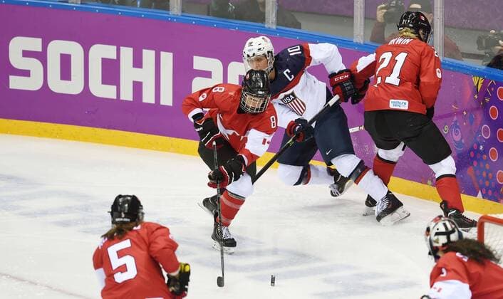 (140220) -- SOCHI, Feb. 20, 2014 (Xinhua) -- Canada s Laura Fortino (2nd, L) defenses during the women s gold medal competition of Ice Hocky against the Unitd States at the 2014 Sochi Winter Olympic Games in Sochi, Russia, Feb. 20, 2014.(Xinhua Wang Yuguo) (SP)OLY-RUSSIA-SOCHI-ICE HOCKY-WOMEN S GOLD MEDAL-CAN VS USA 