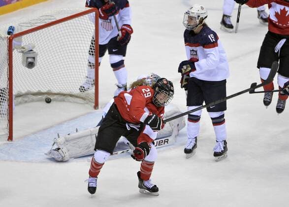 Canada s Marie-Philip Poulin (R) celebrates as she scores during the third period of the women s gold medal ice hockey game against the United States at the Sochi 2014 Winter Olympics on February 20, 2014 in Sochi, Russia.  OLY20140220138