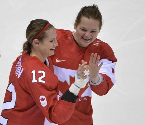 Canada s Meaghan Mikkelson (L) and Jennifer Wakefield celebrate after defeating the United States to win the women s ice hockey game at the Sochi 2014 Winter Olympics on February 20, 2014 in Sochi, Russia. Canada won 3-2 in overtime.  OLY20140220153