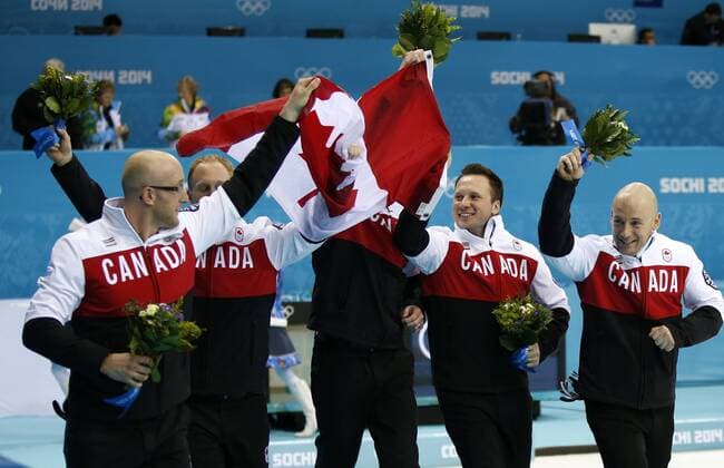 (140221) -- SOCHI, Feb. 21, 2014 (Xinhua) -- Players of Canada celebrate during the flower ceremony after the men s gold medal game of Curling between Canada and Great Britain at the 2014 Sochi Winter Olympic Games in Sochi, Feb. 21, 2014. Canada won 9-3 and claimed the gold medal of the event. (Xinhua Wang Lili) (SP)OLY-RUSSIA-SOCHI-CURLING-MEN S GOLD MEDAL GAME 