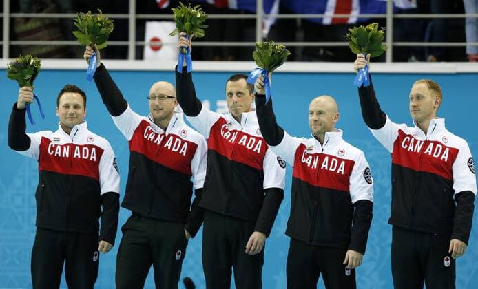 (140221) -- SOCHI, Feb. 21, 2014 (Xinhua) -- Players of Canada pose during the flower ceremony after the men s gold medal game of Curling between Canada and Great Britain at the 2014 Sochi Winter Olympic Games in Sochi, Feb. 21, 2014. Canada won 9-3 and claimed the gold medal of the event. (Xinhua Wang Lili) (SP)OLY-RUSSIA-SOCHI-CURLING-MEN S GOLD MEDAL GAME 