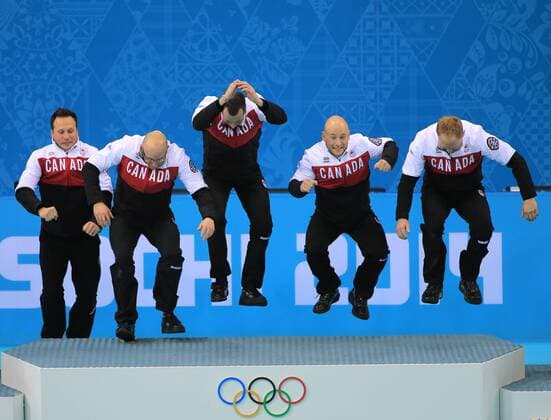 ITAR-TASS: RUSSIA. FEBRUARY 21, 2014. Canada s Caleb Flaxey, Ryan Harnden, E.J. Harnden, Ryan Fry, and Brad Jacobs (L-R) pose at a flower ceremony after winning the men s curling final match against Great Britain at the Sochi 2014 Winter Olympics, at the Ice Cube Curling Centre. The Canadian team won the game 9:3.  RE13A88F