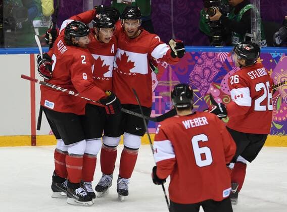 Players of Canada celebrate after scoring during the men s gold medal game of Ice Hockey between Canada and Sweden at the 2014 Sochi Winter Olympic Games in Sochi, Russia, Feb. 23, 2014. (Xinhua Wang Yuguo) (SP)OLY-RUSSIA-SOCHI-ICE HOCKEY-MEN S GOLD MEDAL GAME-SWE VS CAN 