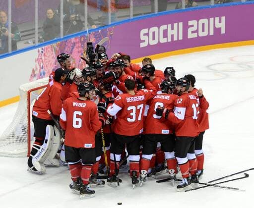 (140223) -- SOCHI, Feb. 23, 2014 (Xinhua) -- Players of Canada celebrate victory after the men s gold medal game of Ice Hockey between Canada and Sweden at the 2014 Sochi Winter Olympic Games in Sochi, Russia, Feb. 23, 2014. Canada won 3-0 and claimed the gold medal of the event. (Xinhua Wang Yuguo) (SP)OLY-RUSSIA-SOCHI-ICE HOCKEY-MEN S GOLD MEDAL GAME-SWE VS CAN 