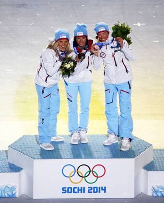 (140223) -- SOCHI, Feb. 23, 2014 (Xinhua) -- Gold medalist Marit Björgen (C) of Norway, silver medalist Therese Johaug (L) of Norway and bronze medalist Kristin Stoermer Steira (R) of Norway pose during the awarding ceremony for the ladies 30km mass start free of cross-country event at the closing ceremony of 2014 Sochi Winter Olympic Games in Sochi, Russia, Feb. 23, 2014. (Xinhua Wang Lili) (SP)OLY-RUSSIA-SOCHI-CROSS COUNTRY-LADIES 30KM MASS START FREE 