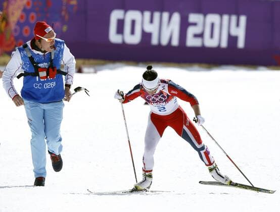 Feb. 22, 2014 - Sochi, Russia - Gold medal winner Marit Bjoergen of Norway is encouraged by a Norwegian coach up the last hill in the Ladies Cross Country 30 km Mass Start at the Laura Cross-Country Ski & Biathlon Center at the at the 2014 Sochi Winter Olympics. Women s Cross Country - Sochi 2014 - ZUMAsc5