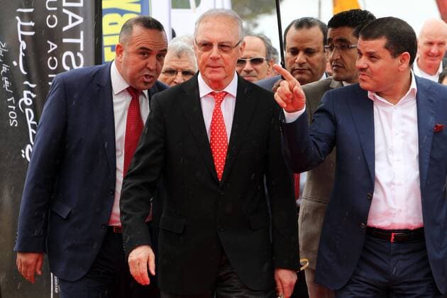 (140226) -- TRIPOLI, Feb. 26, 2014 (Xinhua) -- German football legend Franz Beckenbauer (C) arrives to attend a ceremony for the laying of a foundation stone of Libyan National Stadium that is to host the 2017 Africa Cup of Nations in Tripoli, Libya, on Feb 26, 2014. (Xinhua Hamza Turkia) LIBYA-TRIPOLI-AFR2017-STADIUM 