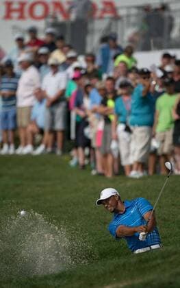 Feb. 27, 2014 - Palm Beach Gardens, FL, USA - Tiger Woods hits out of a bunker on the 18th hole during the first round of the Honda Classic in Palm Beach Gardens, Fla., on Thursday, Feb. 27, 2014. 2014 Honda Classic - ZUMAm67