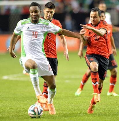 March 5, 2014 - Atlanta, GA, USA - Nigeria s John Obi Mikel, left, and Mexico s Luis Montes (10) battle for the ball during an international friendly soccer match at the Georgia Dorm in Atlanta on Wednesday, March 5, 2014. Nigeria vs. Mexico - ZUMAm67