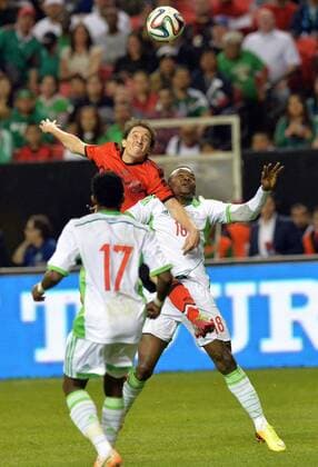 March 5, 2014 - Atlanta, GA, USA - Mexico s Andres Guardado and Nigeria s Victor Obinna, right, battle the ball during the second half of an international friendly at the Georgia Dome in Atlanta on Wednesday, March 5, 2014. Nigeria vs. Mexico - ZUMAm67