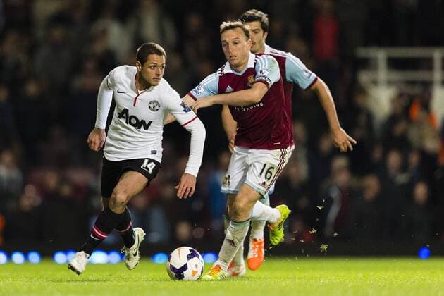 22.03.2014 London, England. Manchester United& x2019;s Javier HERNANDEZ holds off West Ham United s Mark NOBLE during the Premier League game between West Ham United and Manchester United from the Boleyn Ground, Upton Park . xCraigxMercerx  ActionPlus11509973