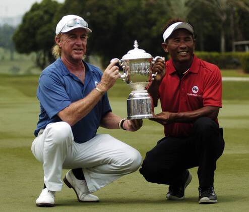 29 March 2014 Kuala Lumpur, Malaysia. Inaugural EurAsia Cup in Kuala Lumpur was a completed remarkable fight by Asia on their last day 10-10. Here is Miguel Angel Jimenez from Spain and Thongchai Jaidee from Thailand holding the EurAsia Cup thophy. Fatin Rosli HBL Network