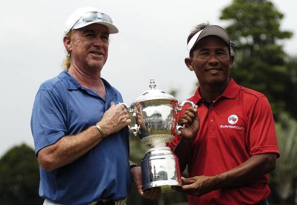 29 March 2014 Kuala Lumpur, Malaysia. Inaugural EurAsia Cup in Kuala Lumpur was a completed remarkable fight by Asia on their last day 10-10. Here is Miguel Angel Jimenez from Spain and Thongchai Jaidee from Thailand holding EurAsia Cup trophy. Fatin Rosli HBL Network