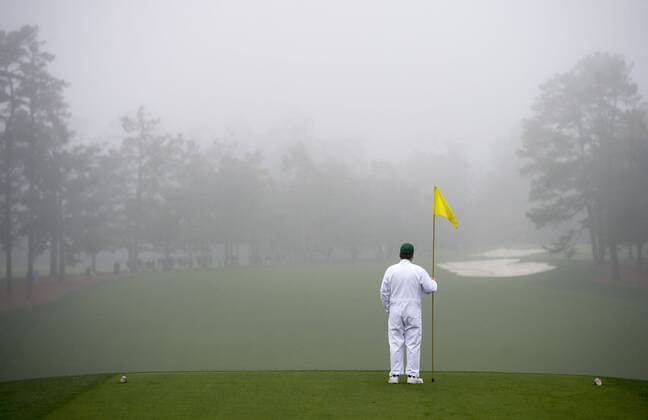 A marshal stands on the first tee as heavy fog comes in during a practice round prior to the Masters golf tournament at Augusta National Golf Club in Augusta, George, April 7, 2014.  AUG20140407301