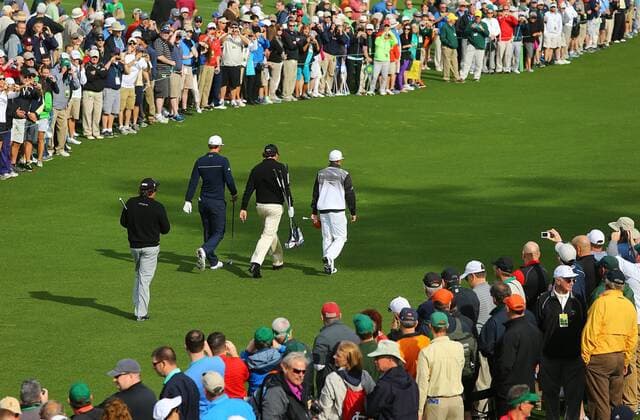 April 8, 2014 - Augusta, GA, USA - The gallery looks on as Jason Dufner, from left, Dustin Johnson, Phil Mickelson, and Rickie Fowler walk down the No. 8 fairway after hitting their drives during their practice round for the Masters at the Augusta National Golf Club, Tuesday, April 8, 2014, in Augusta, Ga. PGA - ZUMAm67
