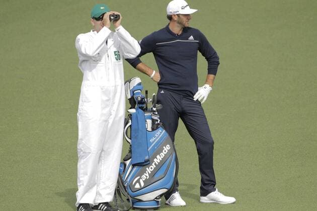 April 8, 2014 - Augusta, GA, USA - Austin Johnson caddying for his brother Dustin, right, looks at the distance to No. 9 green during a practice round at Augusta National Golf Club on Tuesday, April 8, 2014, in Augusta, Ga. PGA - ZUMAm67