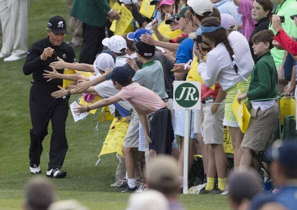Gary Player signs autographs off the ninth green during the Par 3 Contest during the Masters Tournament at Augusta National Golf Club in Augusta, Georgia, April 8, 2014.  AUG20140409336