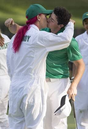 Rory McIlroy kisses his girlfriend Caroline Wozniacki on the ninth hole during the Par 3 Contest during the Masters Tournament at Augusta National Golf Club in Augusta, Georgia, April 8, 2014.  AUG20140409315
