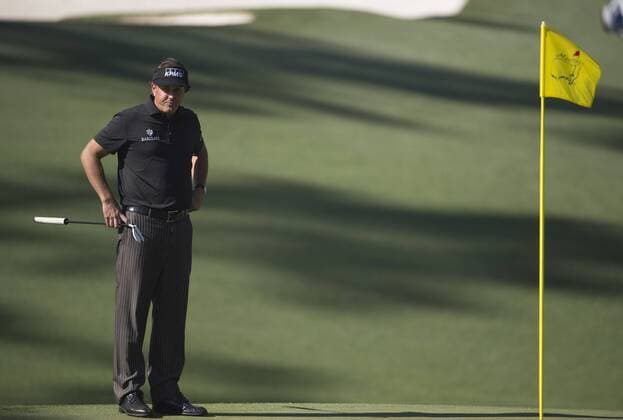 Phil Mickelson waits on the 10th green during the first round of the 2014 Masters Tournament at Augusta National Golf Club in Augusta, Georgia, April 10, 2014.  AUG20140410354