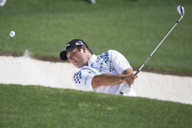 Patrick Reed hits from a bunker on the 18th hole during the first round of the 2014 Masters Tournament at Augusta National Golf Club in Augusta, Georgia, April 10, 2014.  AUG20140410359