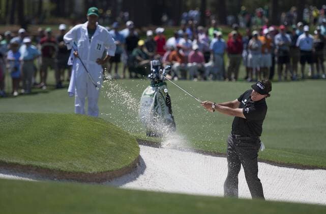 Phil Mickelson hits from a bunker on the second hole during the first round of the 2014 Masters Tournament at Augusta National Golf Club in Augusta, Georgia, April 10, 2014.  AUG20140410370