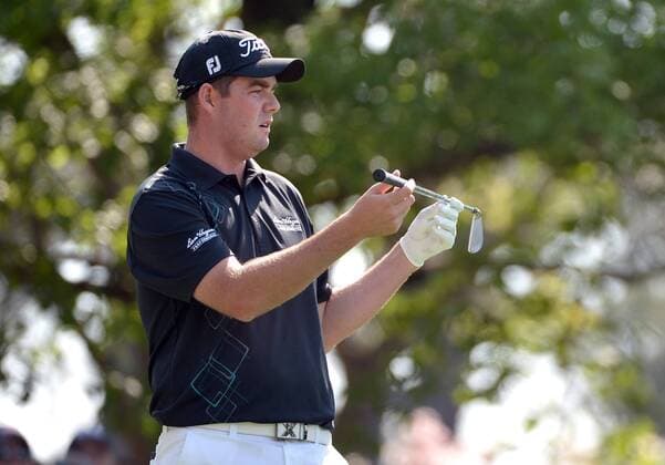 Marc Leishman looks at his club before hitting off of the 4th tee during the second round of the 2014 Masters Tournament at Augusta National Golf Club in Augusta, Georgia, April 11, 2014. Watson finished seven under par.  AUG20140411311