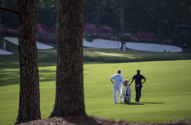 Rory McIlroy and his caddie Jean-Paul Fitzgerald fait on the 13th fairway during the second round of the 2014 Masters Tournament at Augusta National Golf Club in Augusta, Georgia, April 11, 2014.  AUG20140411342