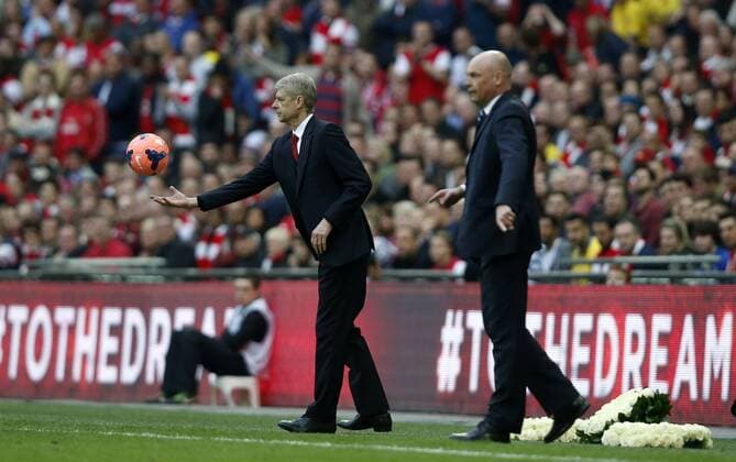 Arsene Wenger (L), manager of Arsenal and Uwe Rosler, manager of Wigan Athletic, look on during FA Cup semifinal match between Arsenal and Wigan Athletic at Wembley Stadium in London, Britain, on April 12, 2014. Arsenal advanced to the final with winning 4-2 on penalties after a 1-1 draw. (Xinhua Wang Lili) FOR EDITORIAL USE ONLY. NOT FOR SALE FOR MARKETING OR ADVERTISING CAMPAIGNS. NO USE WITH UNAUTHORIZED AUDIO, VIDEO, DATA, FIXTURE LISTS, CLUBLEAGUE LOGOS OR LIVE SERVICES. ONLINE IN-MATCH USE LIMITED TO 45 IMAGES, NO VIDEO EMULATION. NO USE IN BETTING, GAMES OR SINGLE CLUBLEAGUEPLAYER PUBLICATIONS. (SP)BRITAIN-LONDON-SOCCER-FA CUP-ARSENAL VS WIGAN 