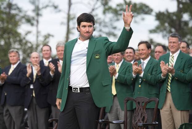 Bubba Watson waves after receiving the green jacket after winning the 2014 Masters at Augusta National Golf Club in Augusta, Georgia, April 13, 2014. Watson won his second Masters with an eight under par finish.  AUG20140413410