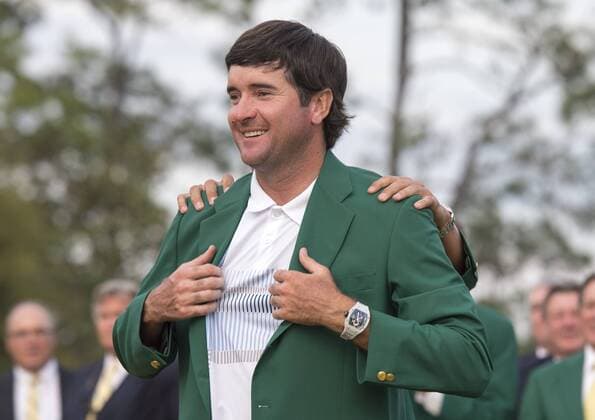 Bubba Watson is presented the green jacket by 2013 Masters champion Adam Scott, after Watson won the 2014 Masters at Augusta National Golf Club in Augusta, Georgia, April 13, 2014. Watson finished eight under par.  AUG20140413408