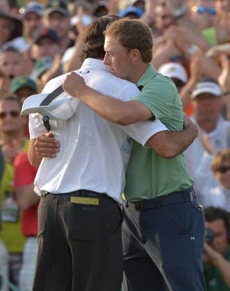 Jordan Spieth hugs Bubba Watson after Watson won the 2014 Masters Tournament at Augusta National Golf Club in Augusta, Georgia, April 13, 2014.  AUG20140413433