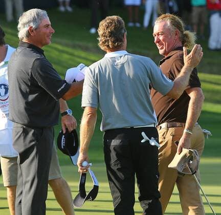 April 20, 2014 - Duluth, GA, USA - Fred Couples (from left) and Bernhard Langer congratulate Miguel Jimenez on the 18th green, as he wins the Greater Gwinnett Championship at TPC Sugarloaf in Duluth, Ga., Sunday, April 20, 2014. Greater Gwinnett Championship - ZUMAm67