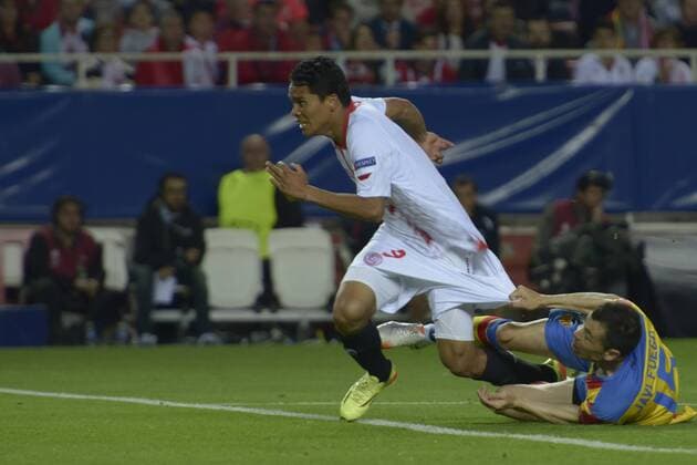 SEVILLE, SPAIN, April 24, 2014: Carlos Bacca is grabbed by Javi Fuego while dangerously close to the goal of Valencia during the match Sevilla FC - Valencia FC Semifinal leg of the Champions League held at the Sanchez Pizjuan stadium in Seville, Spain. (Photo: CarlosBouza Cordon Press)  13300