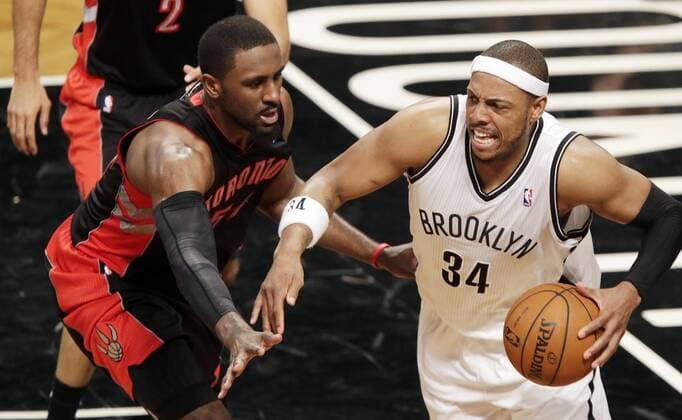 Toronto Raptors Patrick Patterson defends Brooklyn Nets Paul Pierce in the fourth quarter in Game 3 of the Eastern Conference Quarterfinals at Barclays Center in New York City on April 25, 2014. The Nets defeated the Raptors 102-98 and lead the best of 7 series 2-1.  NYP20140425107A