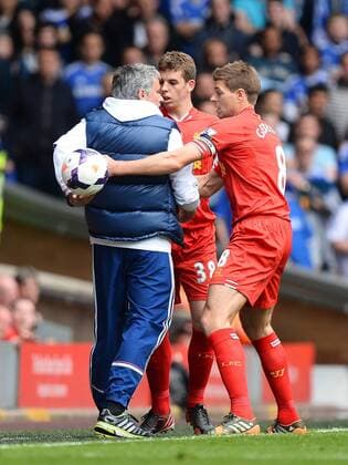 Chelsea manager Jose Mourinho holds the match ball away from Steven Gerrard of Liverpool - at Anfield Stadium - Liverpool FC - England - 27th April 2014 - EDITORIAL USE ONLY. No use with unauthorised audio, video, data, fixture lists, club league logos or live services. Online in-match use limited to 120 images, no video emulation. No use in betting, games or single club league player publications.