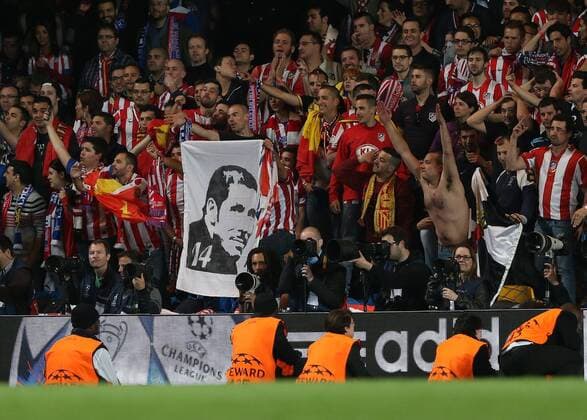 Atletico s fans with a Diego Simeone flag Atletico Madrid - Champions League, Semi Final, 2nd leg- Stamford Bridge - - UK - 30 04 2014 - EDITORIAL USE ONLY. No use with unauthorised audio, video, data, fixture lists, club league logos or live services. Online in-match use limited to 120 images, no video emulation. No use in betting, games or single club league player publications.