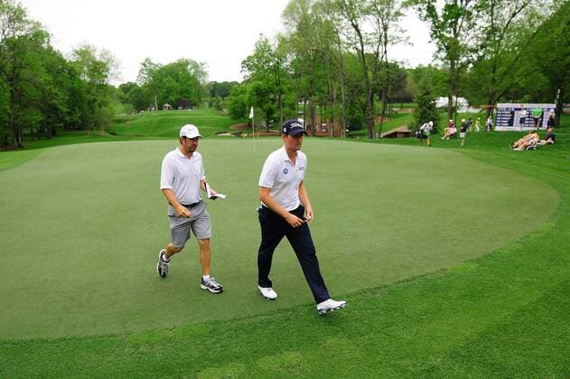 April 30, 2014 - Charlotte, NC, USA - Webb Simpson, left, and his caddie, Paul Tesori walk off the 13th green at Quail Hollow Club in Charlotte, N.C., Wednesday, April 30, 2014. Wells Fargo Championship Pro-Am - ZUMAm67