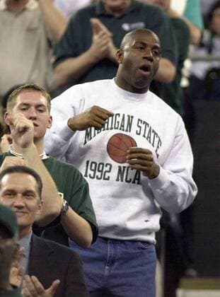 April 2, 2000 - U.S. - KRT SPORTS STORY SLUGGED: FINALFOUR KRT PHOTOGRAPH BY FRANK ANDERSON LEXINGTON HERALD-LEADER (KRT412) INDIANAPOLIS, INDIANA April 1 -- Former Michigan State player Ervin Magic Johnson cheers from the stands during Saturday s semifinal game between the Michigan State Spartans and Wisconsin Badgers at the RCA Dome in Indianapolis, Indiana. (LX) PL KD BL 2000 (smd) (Digital Image) News Archive - April 2, 2000 - ZUMAm67