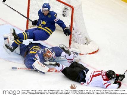 ITAR-TASS: MINSK, BELARUS. MAY 18, 2014. Sweden s Niclas Burstrom, Sweden s goalie Anders Nilsson and Canada s Jonathan Huberdeau (L-R) in action in their 2014 IIHF World Championship Preliminary Round Group A ice hockey match at Chizhovka Arena Stadium. The Canadian team won the game 3:2.  premiumd RE14437B