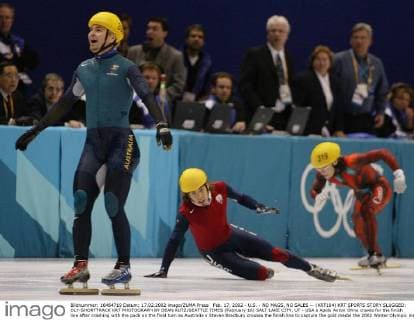 Feb. 17, 2002 - U.S. - NO MAGS, NO SALES -- (KRT104) KRT SPORTS STORY SLUGGED: OLY-SHORTTRACK KRT PHOTOGRAPH BY DEAN RUTZ SEATTLE TIMES (February 16) SALT LAKE CITY, UT - USA s Apolo Anton Ohno crawls for the finish line after crashing with the pack on the final turn as Australia s Steven Bradbury crosses the finish line to capture the gold medal the 2002 Winter Olympic men s 1000m short track speedskating competition, Saturday, February 16, 2002, at the Salt Lake Ice Center in Salt Lake City, Utah. (SE) AP NC KD BL 2002 (Horiz) (Digital image) (smd) (Additional photos available on KRT Direct, KRT NewsCom or upon request) News Archive - Feb. 17, 2002 - ZUMAm67