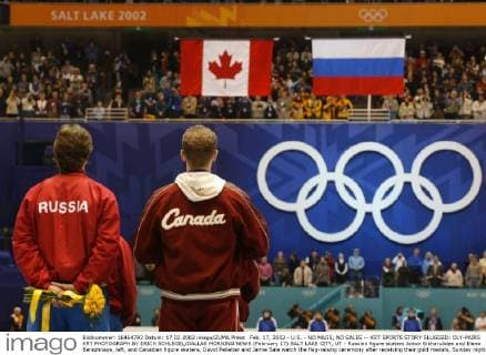 Feb. 17, 2002 - U.S. - NO MAGS, NO SALES -- KRT SPORTS STORY SLUGGED: OLY-PAIRS KRT PHOTOGRAPH BY ERICH SCHLEGEL DALLAS MORNING NEWS (February 17) SALT LAKE CITY, UT - Russian figure skaters Anton Sikharulidze and Elena Berezhnaya, left, and Canadian figure skaters, David Pelletier and Jamie Sale watch the flag-raising ceremony after receiving their gold medals, Sunday night, February 17, at the Salt Lake Ice Center, for the 2002 Winter Olympic Pairs competition. The two couples were both awarded the gold medal after a French judge admitted to foul play. (DA) NC KD BL 2002 (Horiz) (Digital image) (smd) News Archive - Feb. 17, 2002 - ZUMAm67