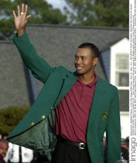 April 12, 2002 - U.S. - KRT SPORTS STORY SLUGGED: MASTERS KRT PHOTO BY JASON CLARK THE STAMP (April 14) AUGUSTA, GA -- Tiger Woods waves to the crowd wearing his Masters green jacket, his third Masters title and second consecutive. (KRT) NC KD BL 2002 (Vert) (gsb) News Archive - April 12, 2002 - ZUMAm67