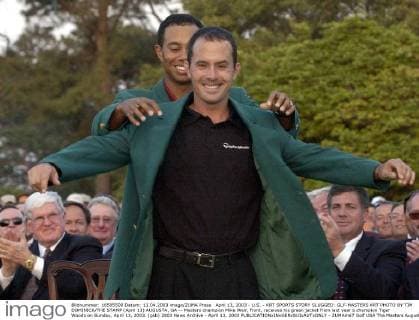 April 13, 2003 - U.S. - KRT SPORTS STORY SLUGGED: GLF-MASTERS KRT PHOTO BY TIM DOMINICK THE STAMP (April 13) AUGUSTA, GA -- Masters champion Mike Weir, front, receives his green jacket from last year s champion Tiger Woods on Sunday, April 13, 2003. (gsb) 2003 News Archive - April 13, 2003 - ZUMAm67