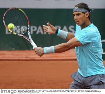 Rafael Nadal of Spain hits a shot during his French Open men s first round match at Roland Garros in Paris on May 26, 2014.  PAR20140526713