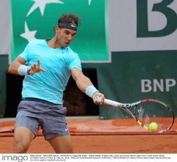 Rafael Nadal of Spain hits a shot during his French Open men s first round match at Roland Garros in Paris on May 26, 2014.  PAR20140526723