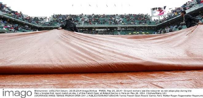 PARIS, May 26, 2014 - Ground workers use the raincover as rain stops play during the Men s Singles first round match on day 2 of the French Open at Roland Garros in Paris on May 26, 2014. (Xinhua Wang Lili) (SP)FRANCE-PARIS-TENNIS-FRENCH OPEN-DAY 2 