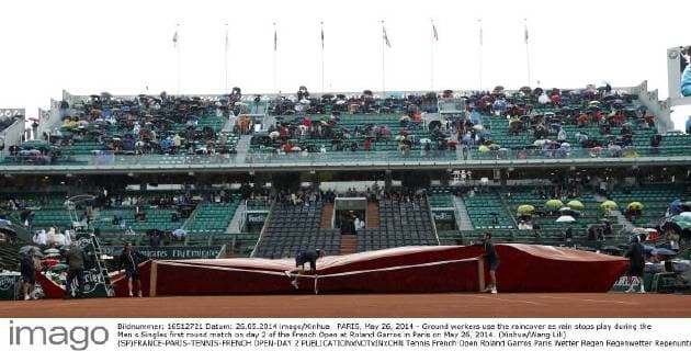 PARIS, May 26, 2014 - Ground workers use the raincover as rain stops play during the Men s Singles first round match on day 2 of the French Open at Roland Garros in Paris on May 26, 2014. (Xinhua Wang Lili) (SP)FRANCE-PARIS-TENNIS-FRENCH OPEN-DAY 2 