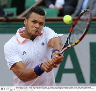 Jo-Wilfried Tsonga of France hits a shot during his French Open men s second round match at Roland Garros in Paris on May 28, 2014.  PAR20140528817