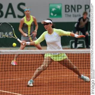 China s Zheng Saisai and Vera Dushevina of Russia compete duruing the Women s doubles second round match at Roland Garros in Paris on May 30, 2014. 