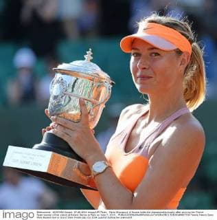 Maria Sharapova of Russia holds the championship trophy after winning her French Open women s final match at Roland Garros in Paris on June 7, 2014. .  PAR20140607704